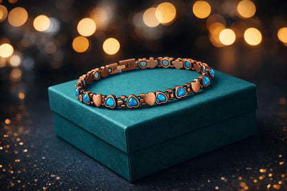 Jewellery Copper bracelet with aqua blue stones on a teal box against a blurred lights background