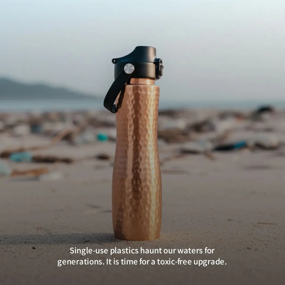 copper water bottle on a beach with text about single-use plastics.