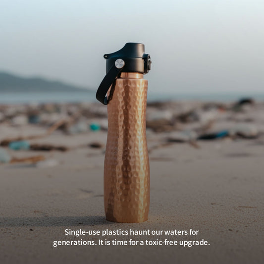 copper water bottle on a beach with text about single-use plastics.
