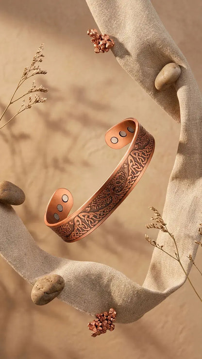 Celtic tree Copper bracelet with intricate design on a natural stone background