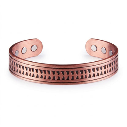 A copper cuff bracelet with arrow embossed patterned design across the front and three circular magnets on each end, shown on a plain white background.