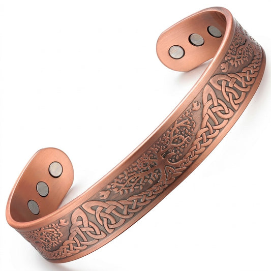 A copper magnetic cuff bracelet with an engraved Celtic tree of life pattern, displayed on a clean white background.