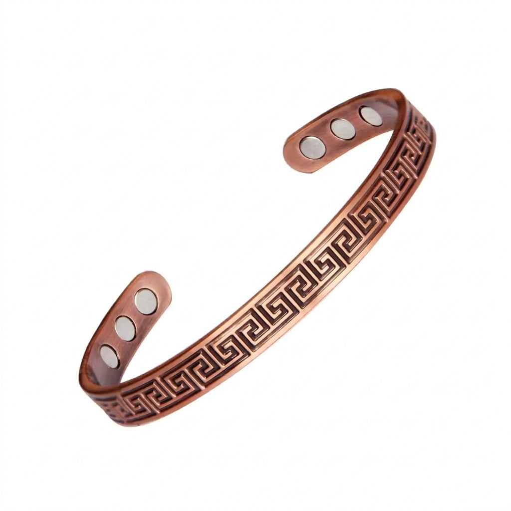 Copper bracelet with embossed greek key pattern, three magnets on each ends on a white background