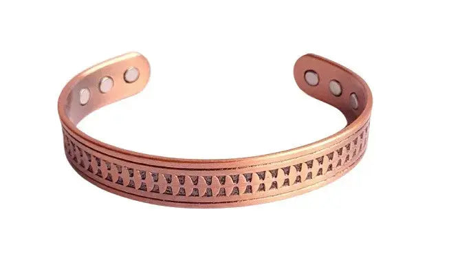 Copper bracelet with embossed geometric pattern on a white background