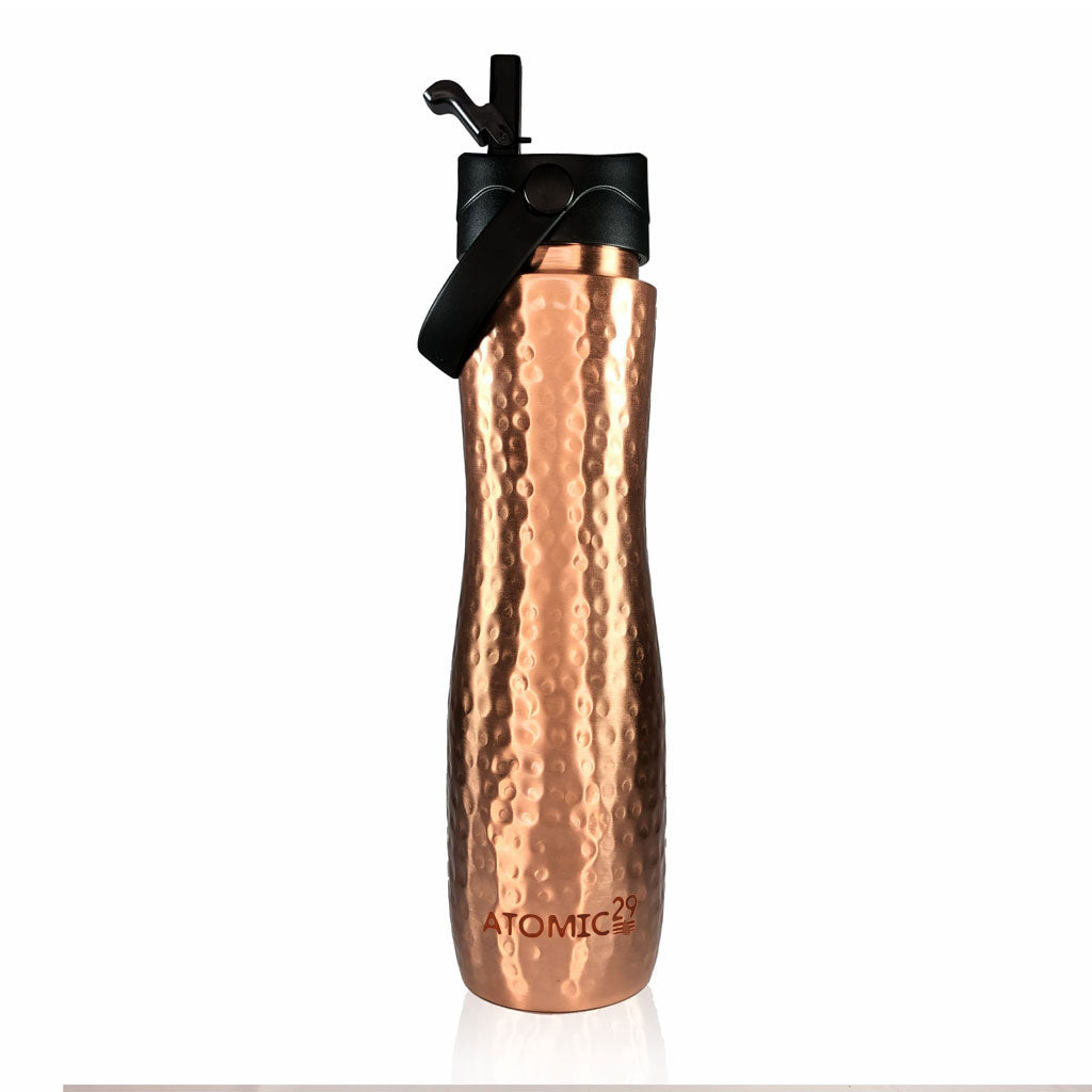 A sports lid hammered copper water bottle with a black lid and carry loop, featuring the 'ATOMIC29' brand logo near the bottom, set against a plain white background.