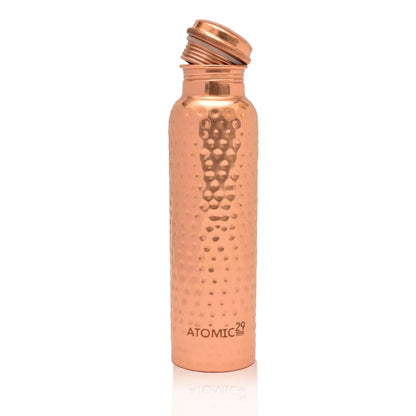 copper water bottle with hammered design on a white background