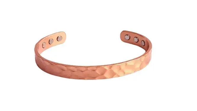 Copper hammered bracelet on a white background