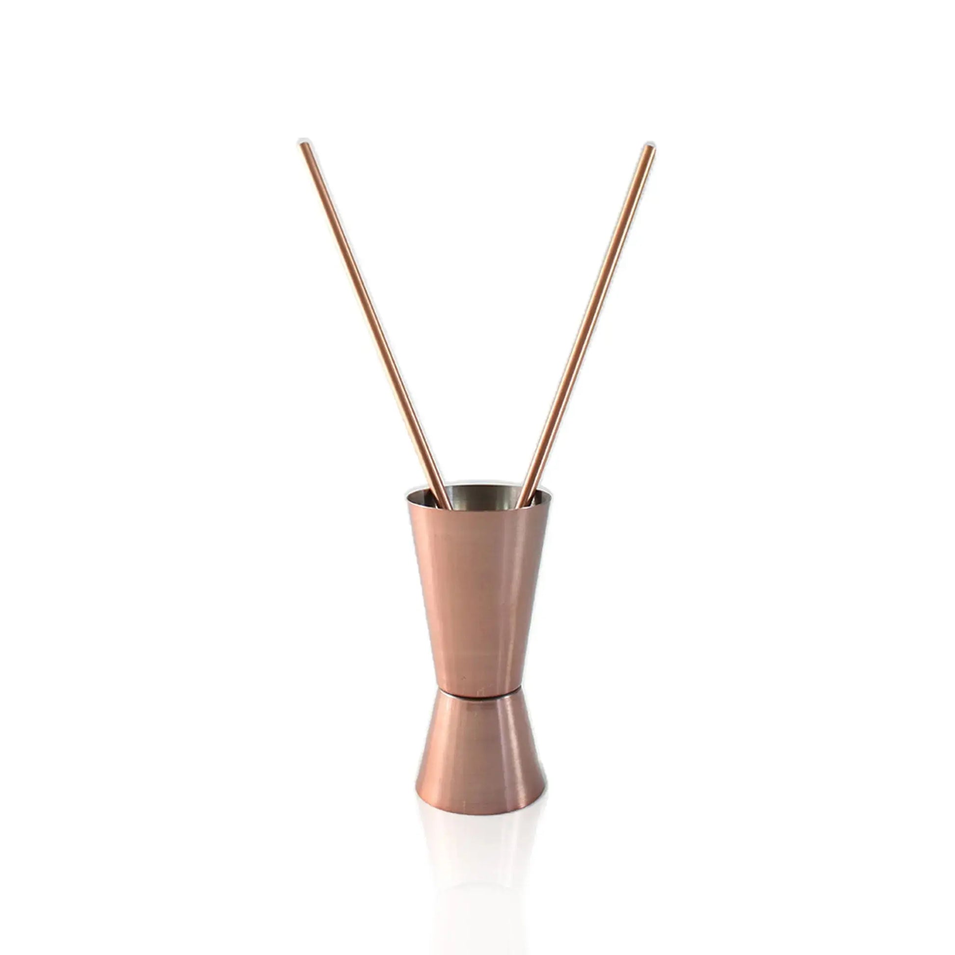 jigger with two copper straws on a white background