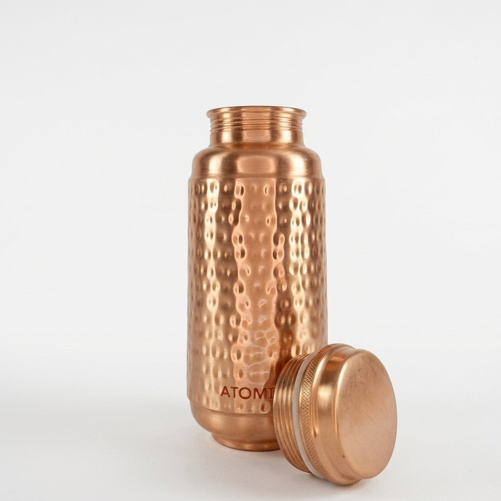 Jumbo copper hammered water bottle with its lid off, standing on a white background. The brand name 'ATOMIC29' is visible near the bottom of the bottle.