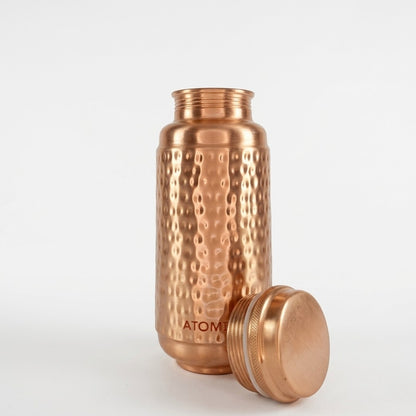 Jumbo copper hammered water bottle with its lid off, standing on a white background. The brand name 'ATOMIC29' is visible near the bottom of the bottle.