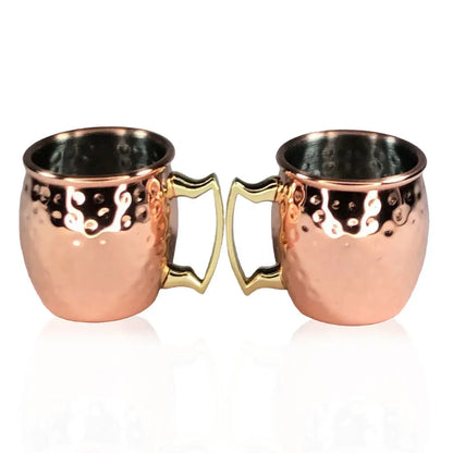 Two copper shot mugs 50ml with gold handles on a white background