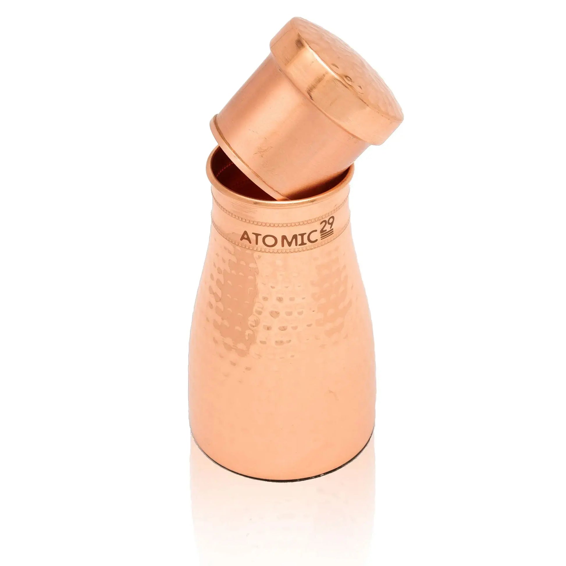 Copper carafe with 'Atomic29' branding on a white background