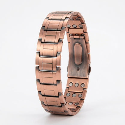 A copper link magnetic bracelet, featuring a brushed finish with darkened accents and magnetic inlay details, set against a plain white background.