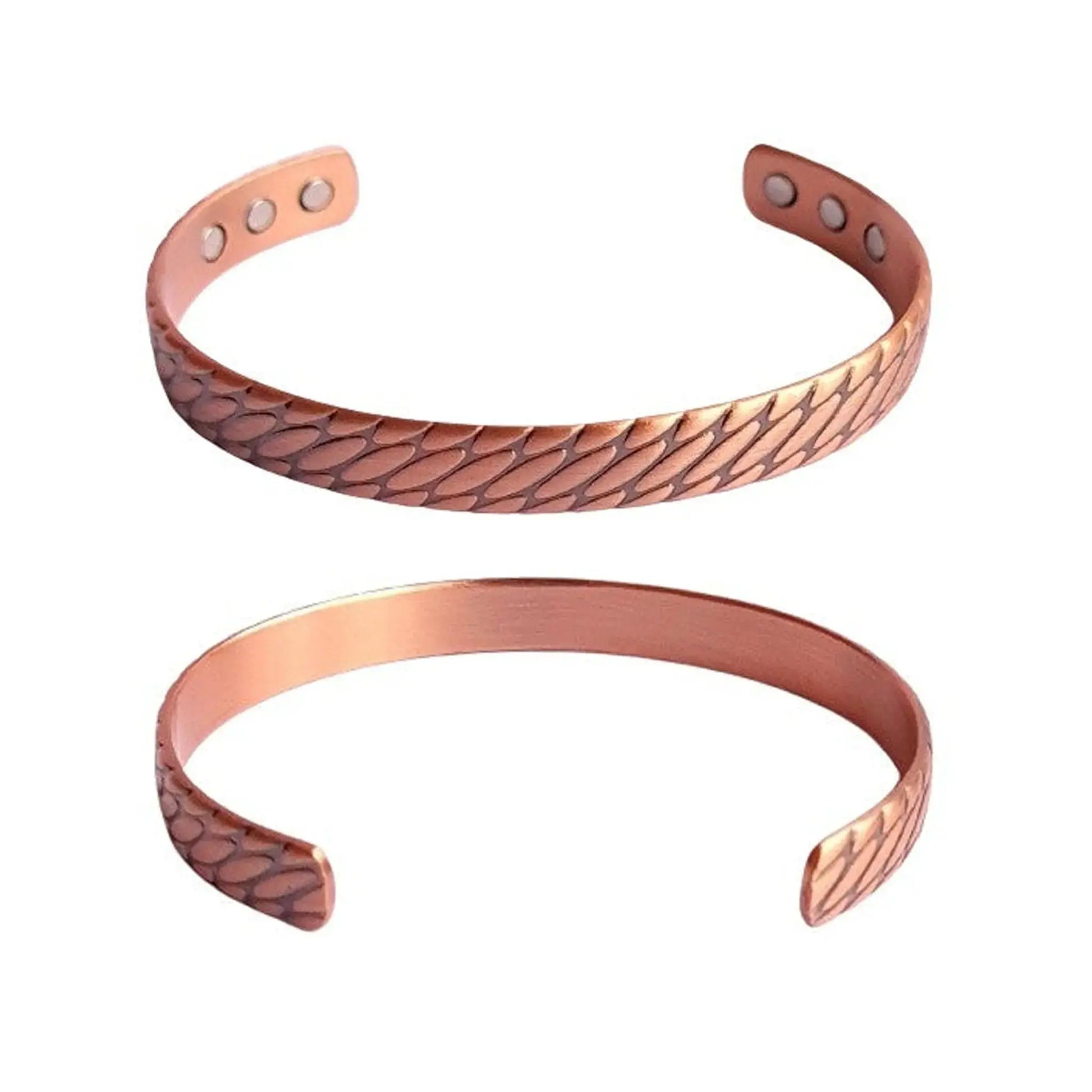 Two copper bracelets with embossed design on a white background