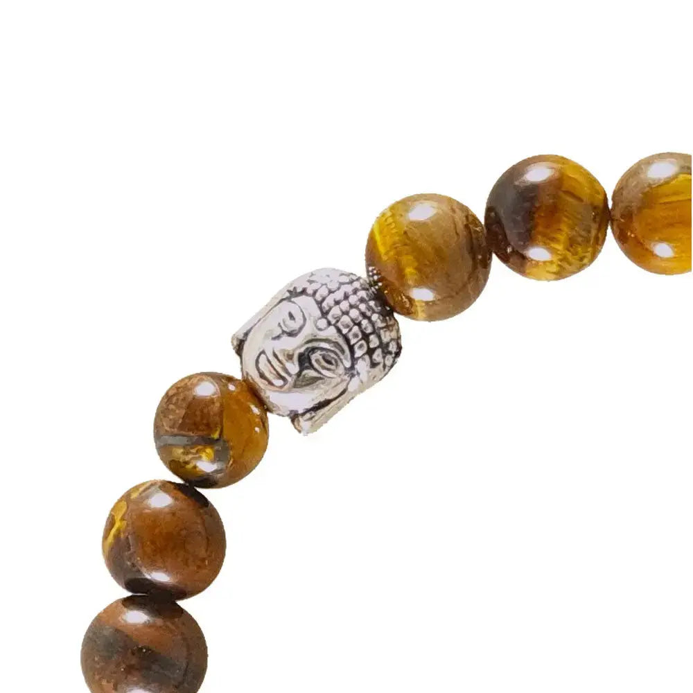 Beaded bracelet with amber beads and a silver Buddha head charm on a white background